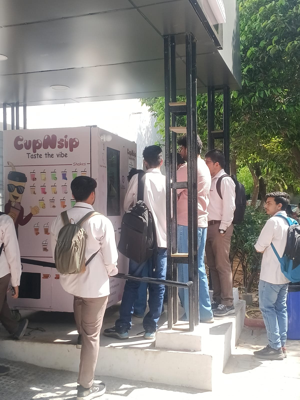 Students gathered around a live Cupnsip machine
